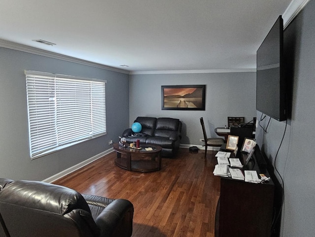 living area with visible vents, crown molding, baseboards, and wood finished floors