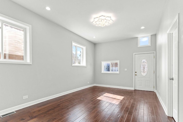 foyer entrance with recessed lighting, visible vents, baseboards, and dark wood-type flooring