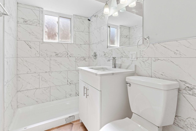 full bath with visible vents, a shower stall, toilet, vanity, and tile walls