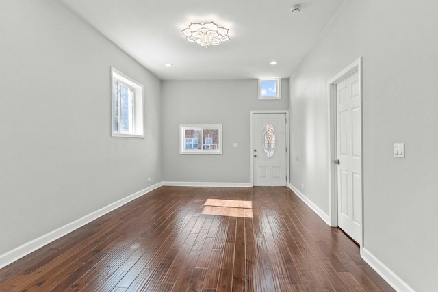 foyer featuring recessed lighting, dark wood-style floors, baseboards, and a wealth of natural light