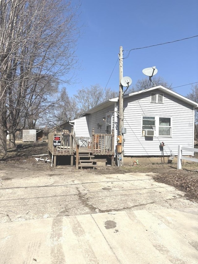 back of house featuring a wooden deck