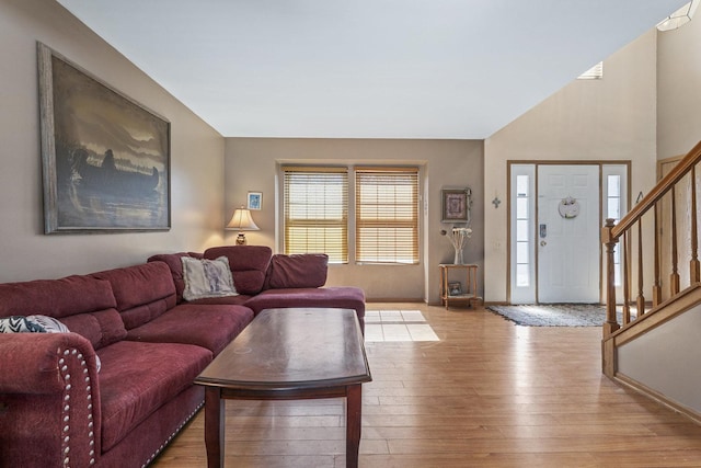 living room with hardwood / wood-style flooring and stairway