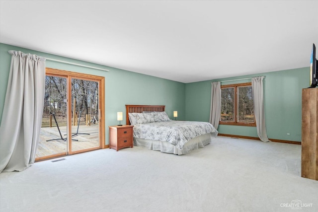 bedroom featuring visible vents, baseboards, carpet flooring, and access to outside