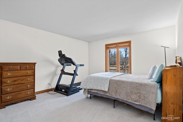 bedroom featuring baseboards and light carpet