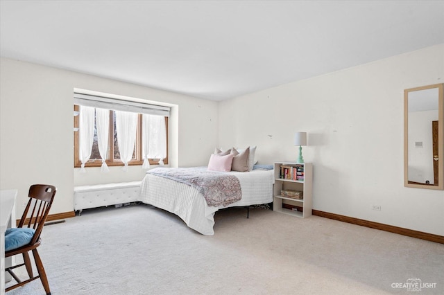 carpeted bedroom featuring baseboards