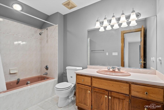 full bathroom with tiled shower / bath combo, toilet, vanity, and tile patterned flooring