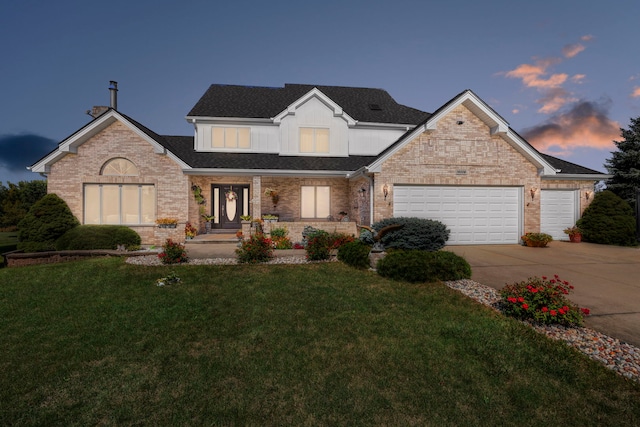 view of front facade featuring a garage, brick siding, a yard, and driveway