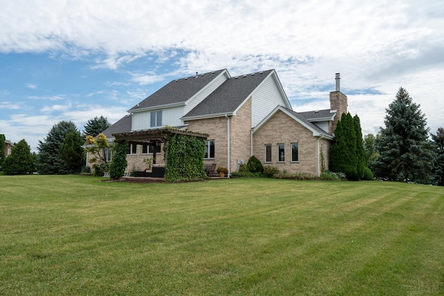 back of property featuring brick siding, a lawn, and a pergola