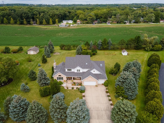 birds eye view of property with a rural view and a view of trees