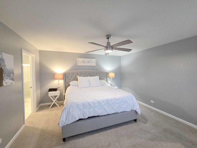 carpeted bedroom with ceiling fan, connected bathroom, and baseboards