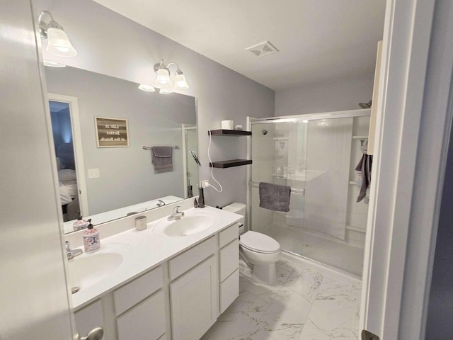 full bath featuring double vanity, a stall shower, a sink, toilet, and marble finish floor