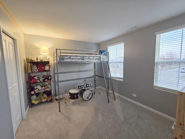 carpeted bedroom with visible vents and baseboards