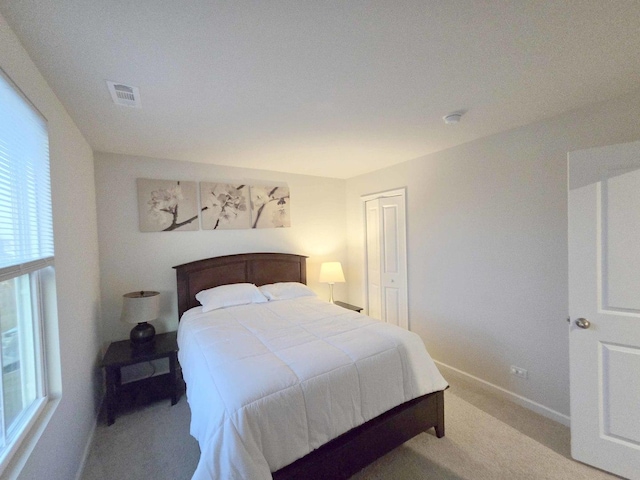 bedroom with visible vents, carpet flooring, and baseboards