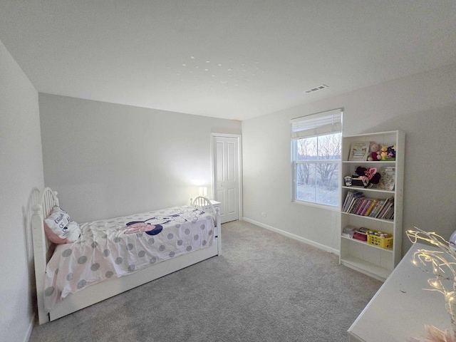 carpeted bedroom featuring visible vents and baseboards