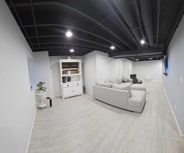 living room with baseboards and light wood finished floors