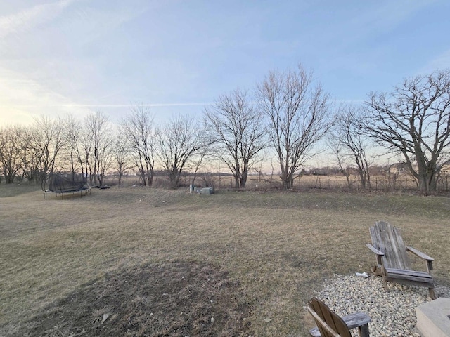 view of yard featuring a rural view and a trampoline