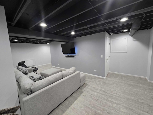 living area with wood finished floors and baseboards