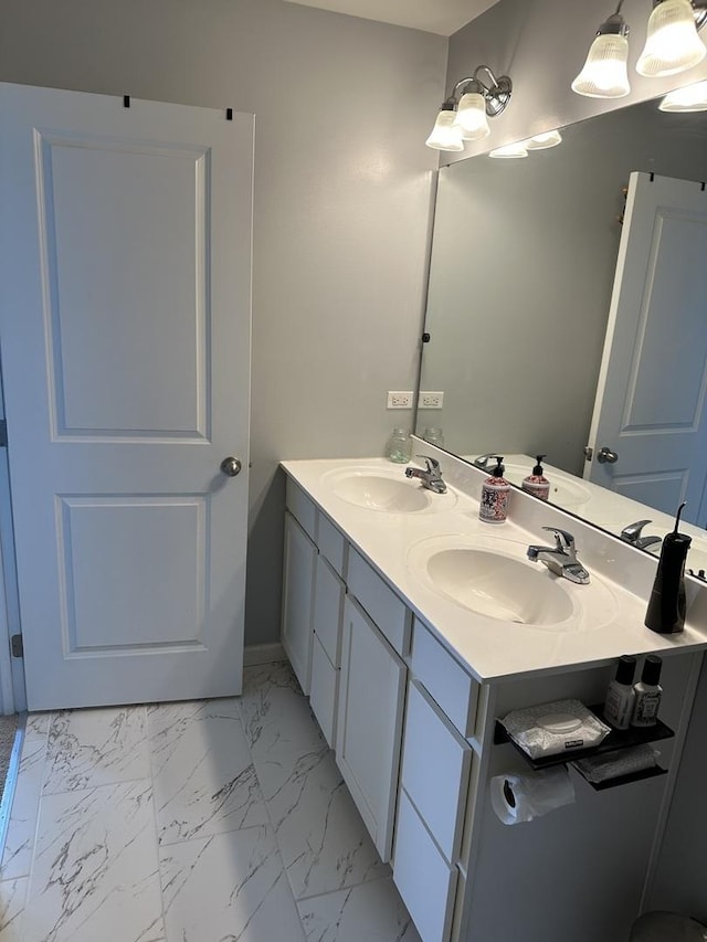 full bathroom featuring a sink, marble finish floor, and double vanity