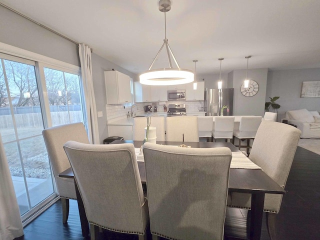 dining room with dark wood-style flooring