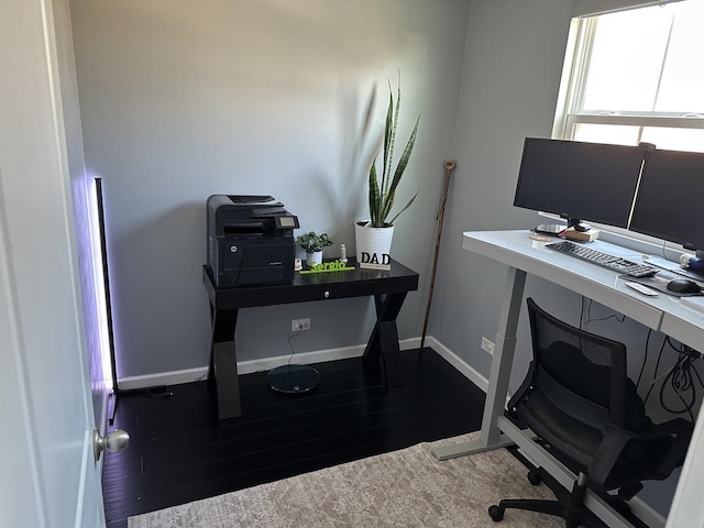 office space with baseboards and wood finished floors