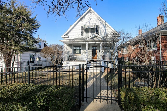 view of front facade featuring a fenced front yard, covered porch, and a gate