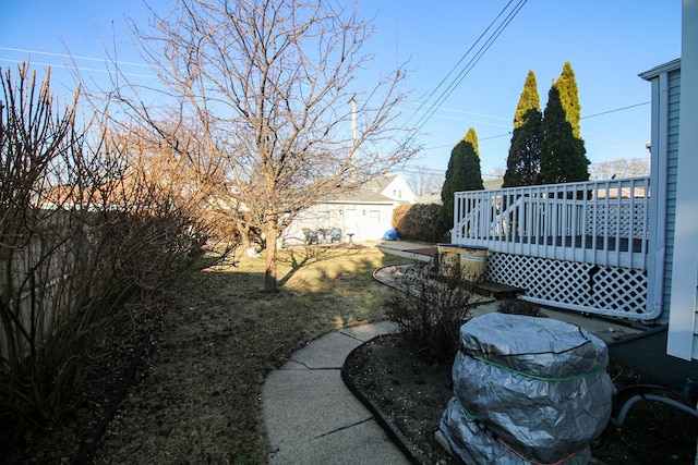 view of yard with a deck and an outdoor structure