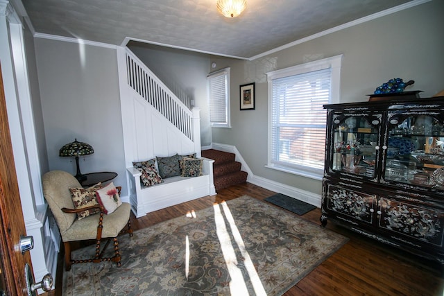 foyer featuring wood finished floors, stairs, and crown molding