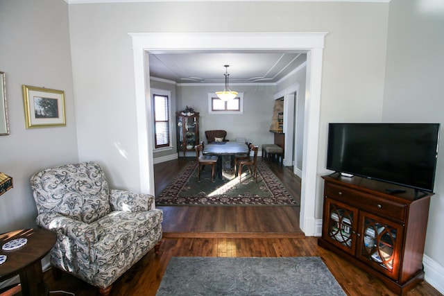 dining area with wood finished floors, baseboards, and ornamental molding