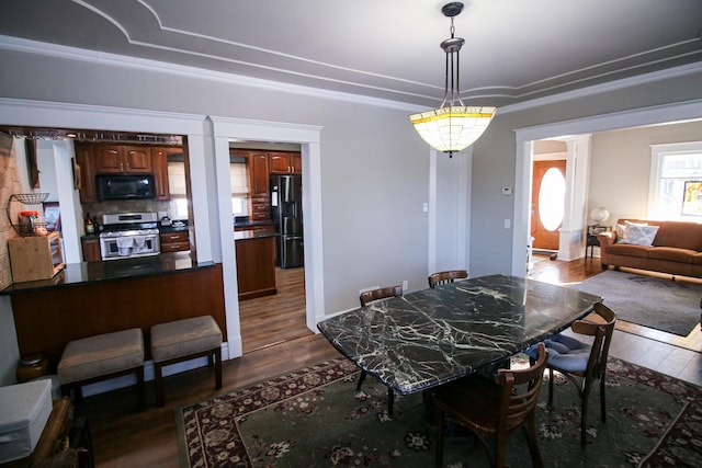 dining space with dark wood finished floors