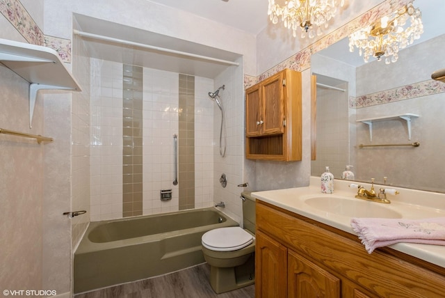 full bath with toilet, shower / tub combination, wood finished floors, a notable chandelier, and vanity