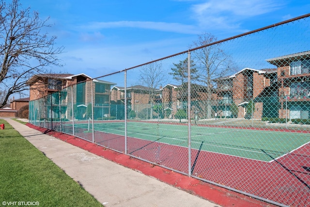 view of tennis court featuring fence