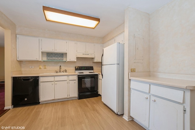 kitchen with freestanding refrigerator, a sink, electric range oven, black dishwasher, and under cabinet range hood