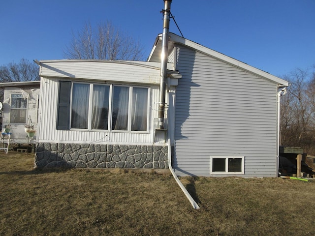 view of side of home featuring a lawn