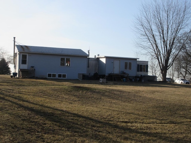 back of property featuring a yard