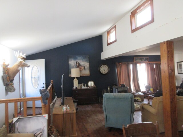 living area featuring wood finished floors and high vaulted ceiling