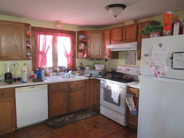 kitchen with white appliances, brown cabinetry, open shelves, a sink, and under cabinet range hood