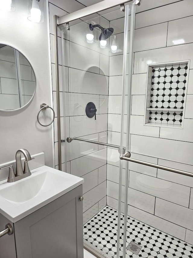 bathroom with vanity and a shower stall