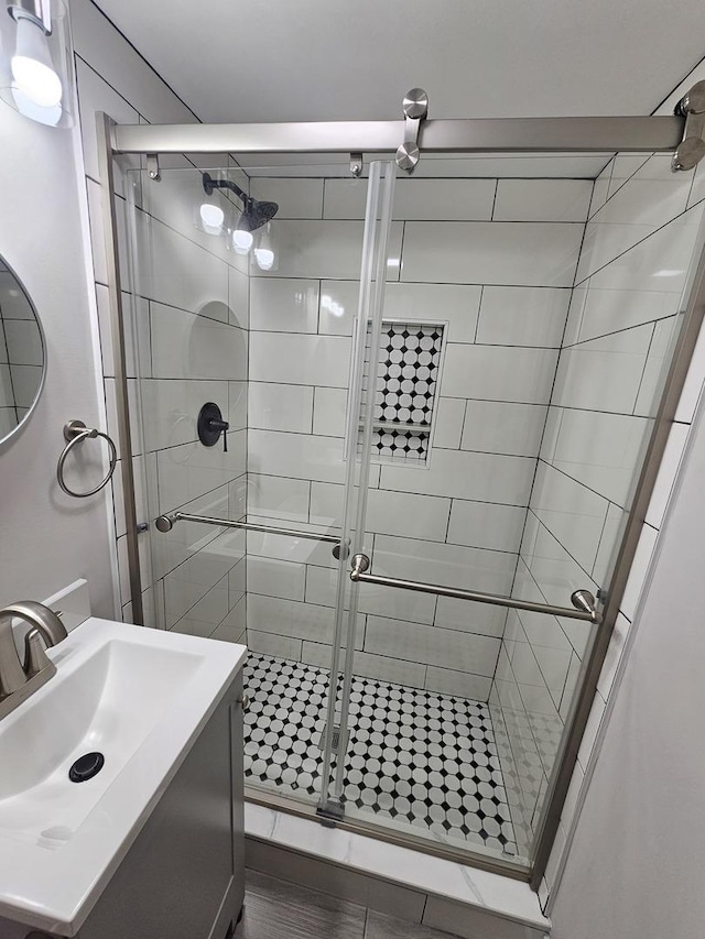 full bath featuring vanity and a shower stall