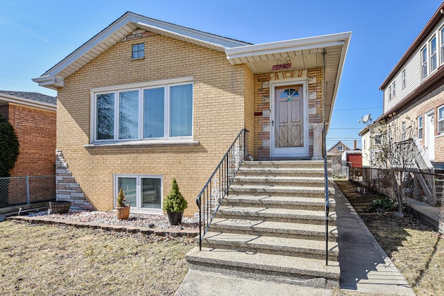 view of front of house with fence and brick siding