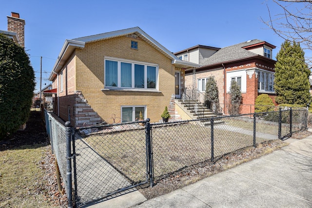 view of front of property with brick siding and a fenced front yard