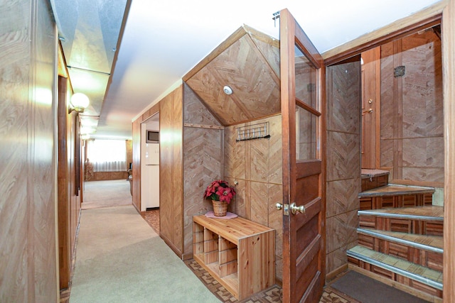 hallway featuring wood walls and carpet floors