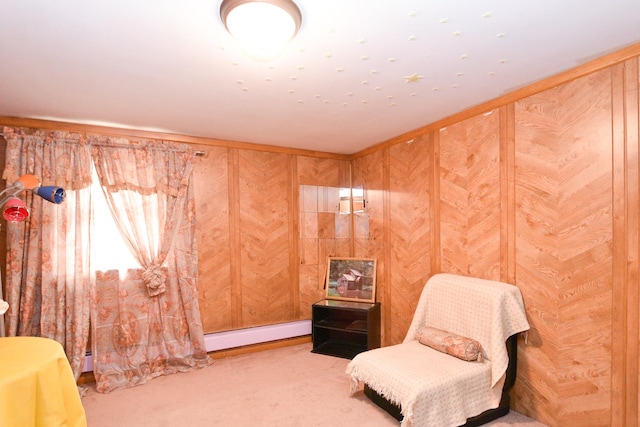 living area with carpet flooring, wood walls, and baseboard heating