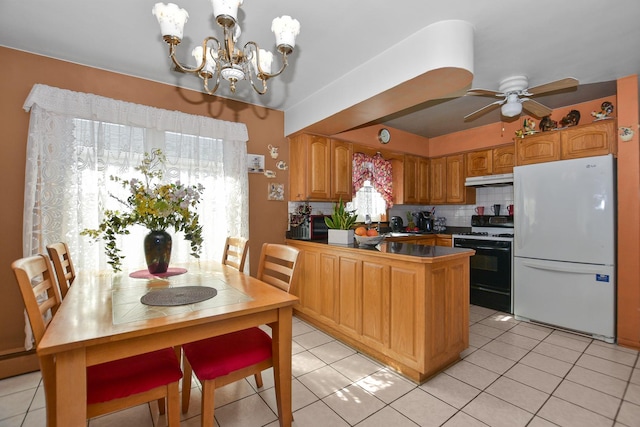 kitchen with ceiling fan with notable chandelier, light tile patterned flooring, gas stove, and freestanding refrigerator