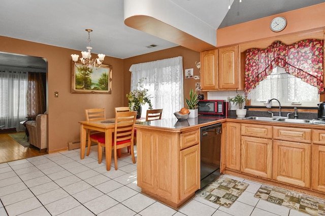 kitchen featuring dishwasher, a notable chandelier, a healthy amount of sunlight, and a sink