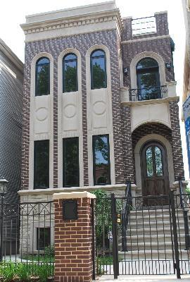 view of front of house with brick siding, a fenced front yard, and a gate