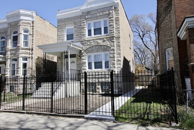 view of front of house featuring a fenced front yard and stone siding