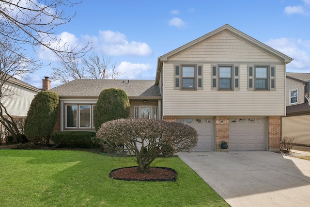 tri-level home with brick siding, concrete driveway, a front yard, roof with shingles, and an attached garage