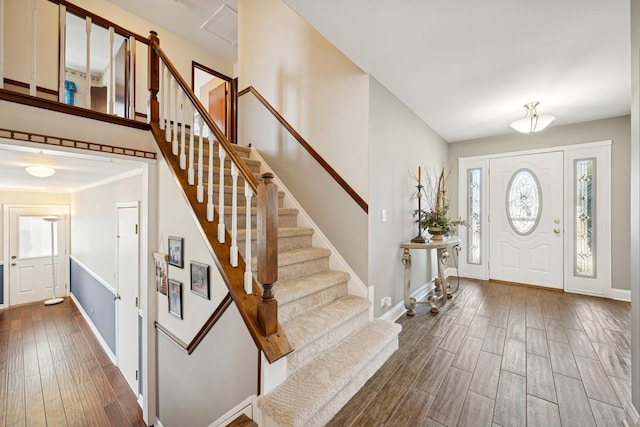 foyer entrance featuring dark wood finished floors and baseboards