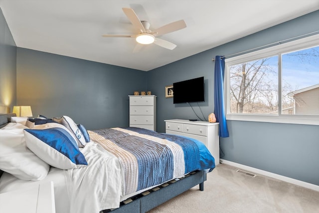 carpeted bedroom featuring visible vents, baseboards, and a ceiling fan