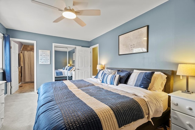 bedroom with baseboards, a ceiling fan, a closet, and light carpet